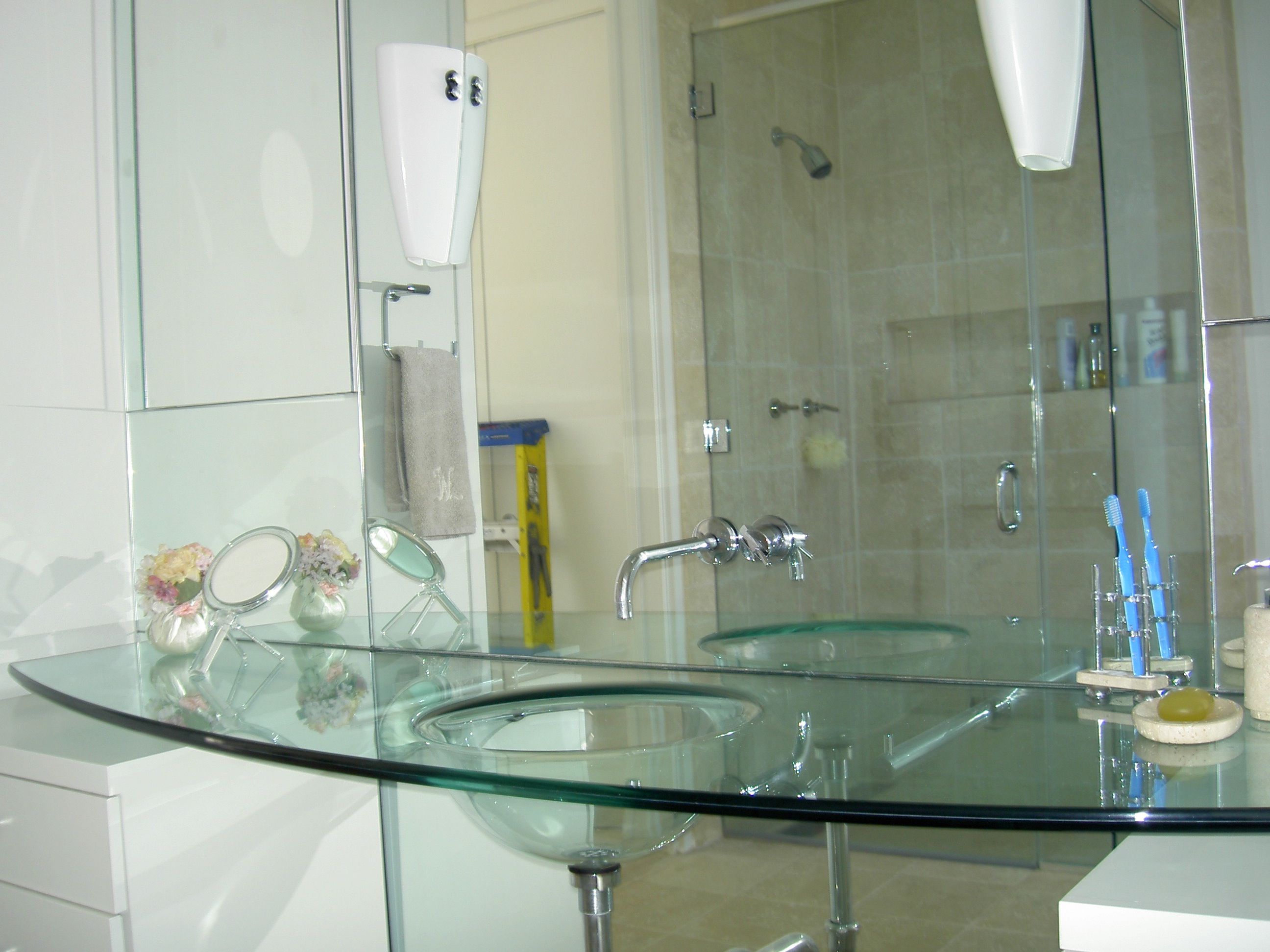 photos of green glass sink in bathroom